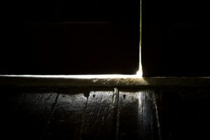 Luce visibile sotto una porta d’ingresso che lascia passare aria fredda